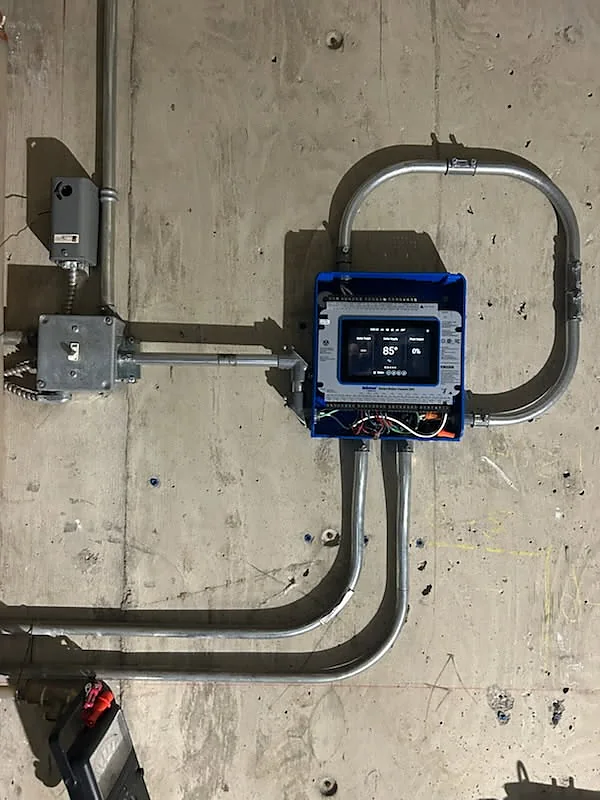 New tekmar smart boiler control being wired and commissioned by PeakFlow Plumbing Calgary