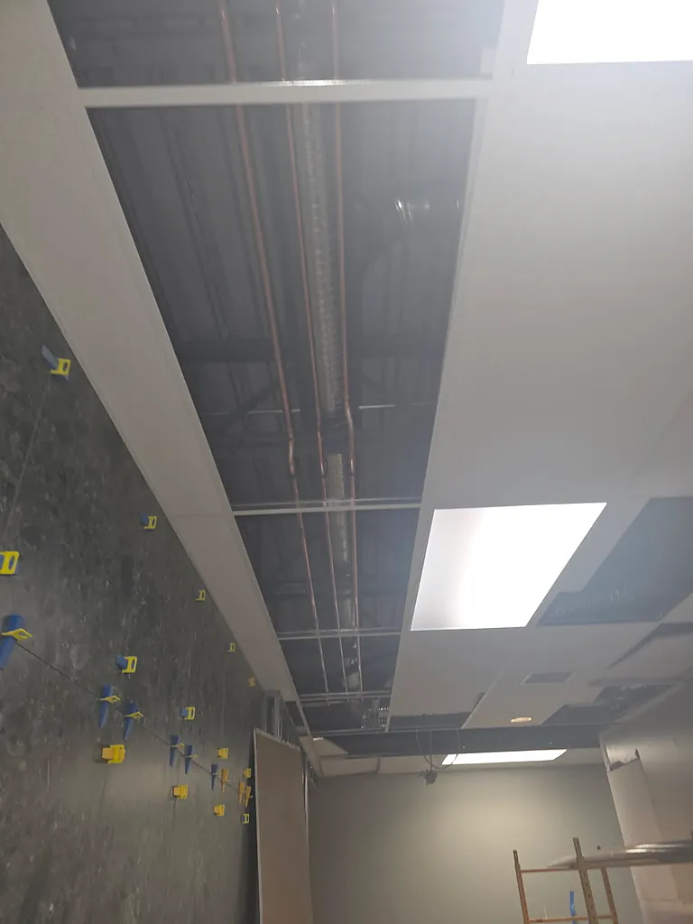 Commercial hot water distribution run photographed before ceiling close-in by PeakFlow Plumbing Calgary